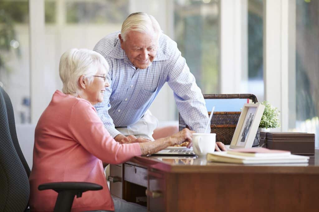 Happy senior couple using a laptop