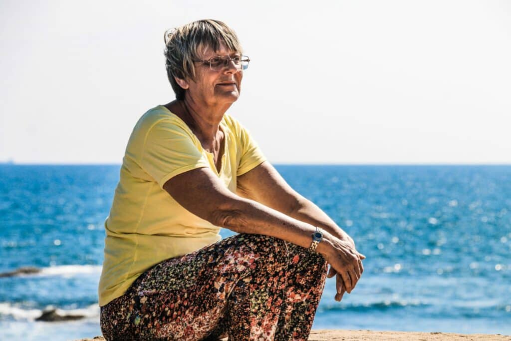 Woman sitting on a beach by the ocean