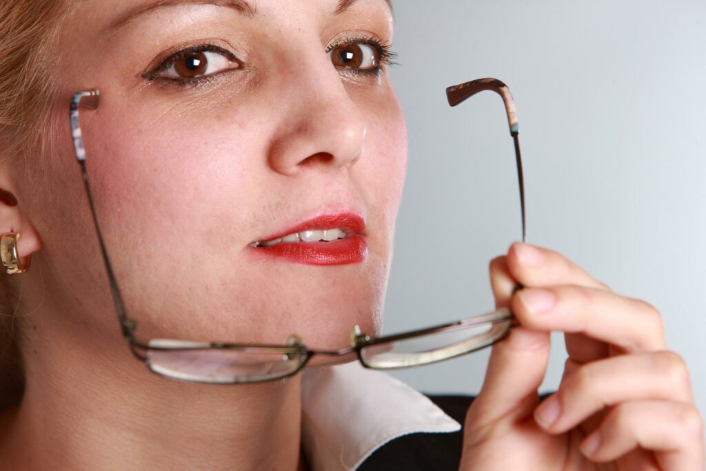 Woman holding eyeglasses