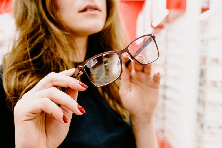 Woman holding eyeglasses at an optical shop