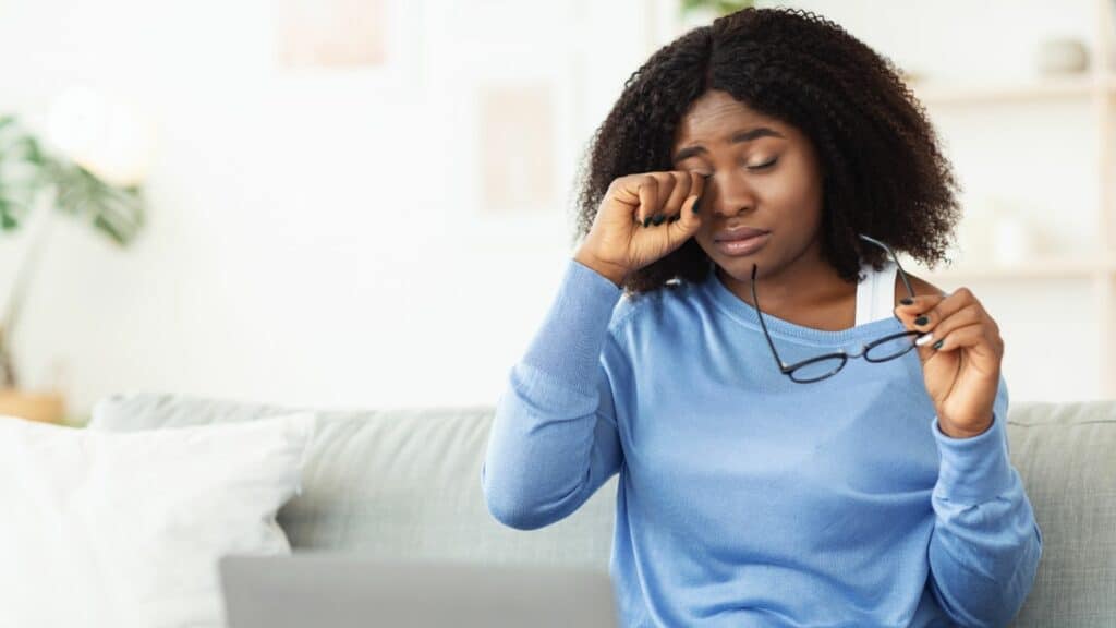 Woman rubbing her irritated dry eyes